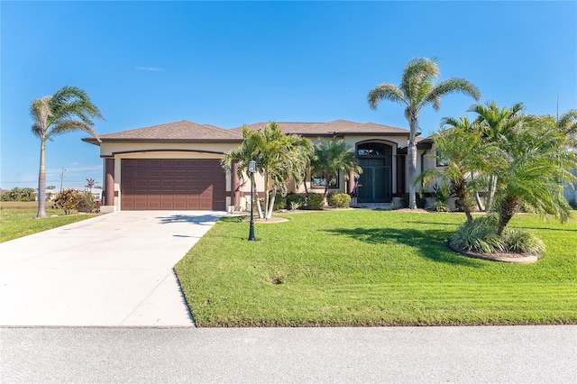 214 W Pine Valley Ln, Rotonda West, FL 33947 - view of front of home with an attached garage, driveway, a front yard, and stucco siding