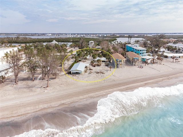 birds eye view of property featuring a water view and a view of the beach