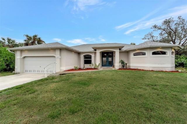 view of front of home featuring a garage, a front yard, and french doors