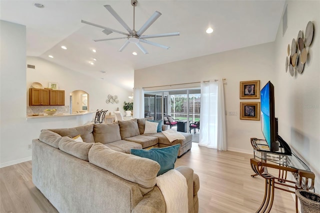 living room with lofted ceiling, light hardwood / wood-style flooring, and ceiling fan