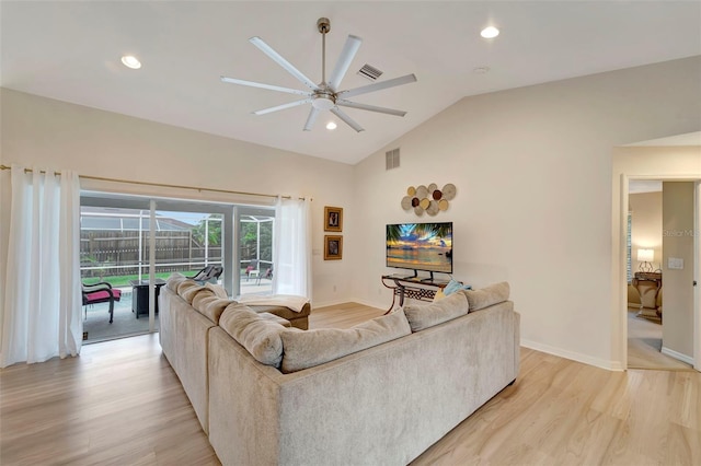 living room with ceiling fan, lofted ceiling, and light wood-type flooring