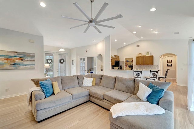 living room featuring lofted ceiling, light hardwood / wood-style floors, and ceiling fan