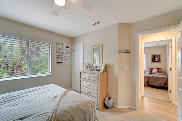 bedroom with light carpet and ceiling fan