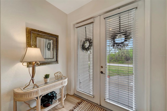 entryway with light hardwood / wood-style floors and french doors