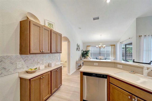 kitchen with lofted ceiling, sink, light hardwood / wood-style flooring, dishwasher, and hanging light fixtures