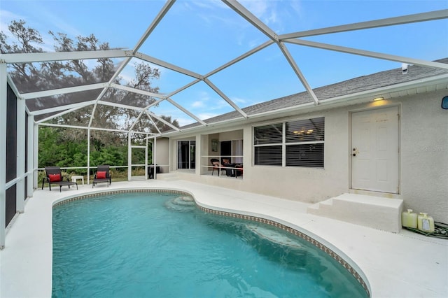 view of swimming pool featuring a lanai and a patio area