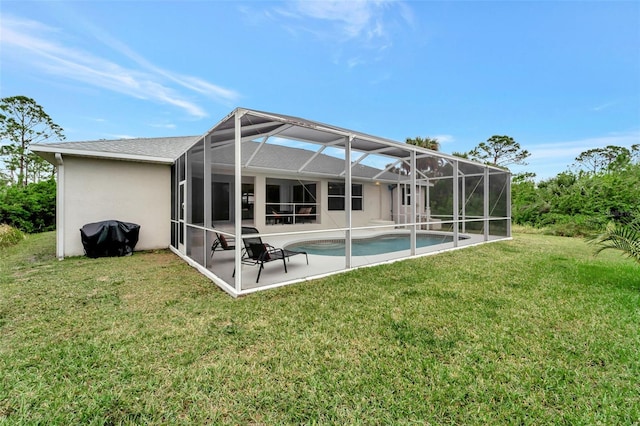 back of property with a yard, a lanai, and a patio area