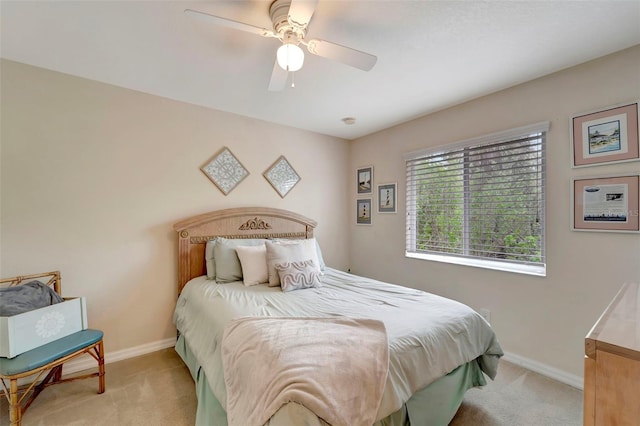 bedroom featuring ceiling fan and light carpet