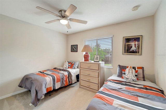 bedroom with ceiling fan and light colored carpet