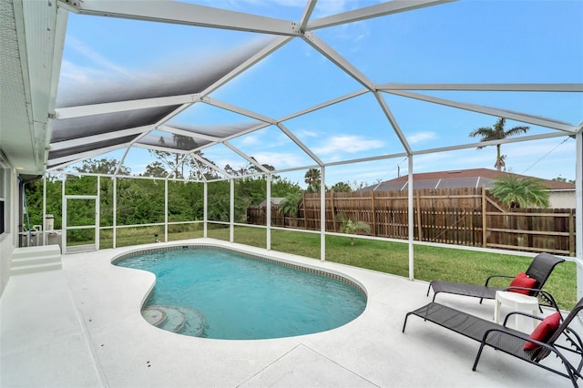 view of pool with a lanai, a lawn, and a patio area