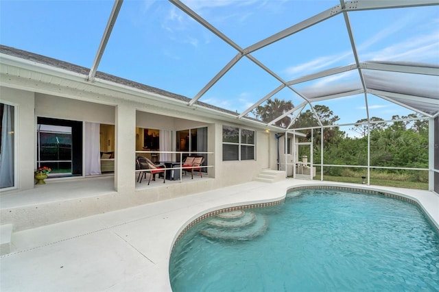 view of swimming pool with a lanai and a patio area