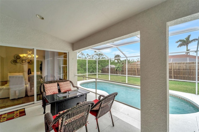 view of swimming pool with a lanai and a patio area