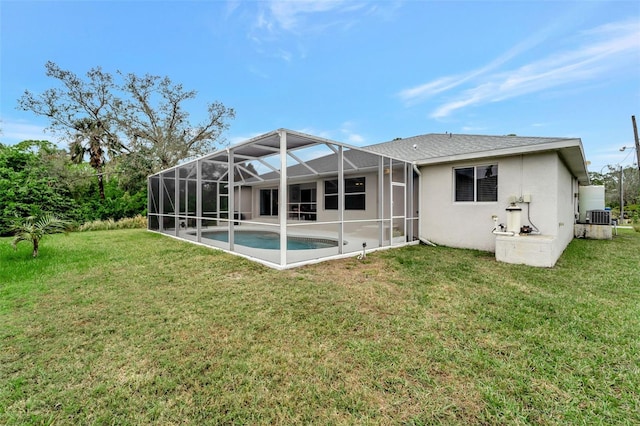 back of property with cooling unit, a yard, a lanai, and a patio area