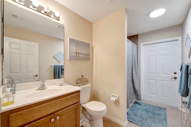 bathroom with vanity, toilet, and tile patterned flooring