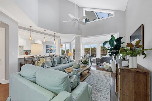 living room featuring high vaulted ceiling, ceiling fan, and dark hardwood / wood-style flooring