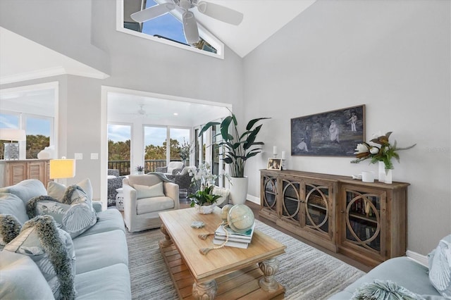 living room with wood-type flooring, high vaulted ceiling, and ceiling fan