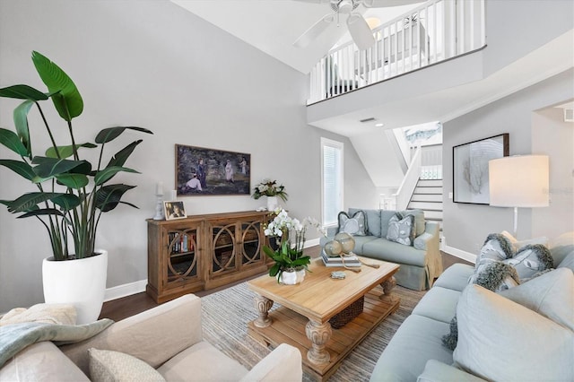 living room with wood-type flooring, high vaulted ceiling, and ceiling fan