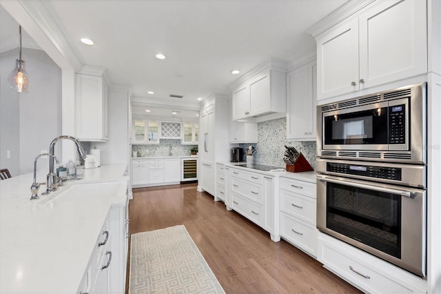 kitchen featuring white cabinets, stainless steel appliances, wine cooler, and sink