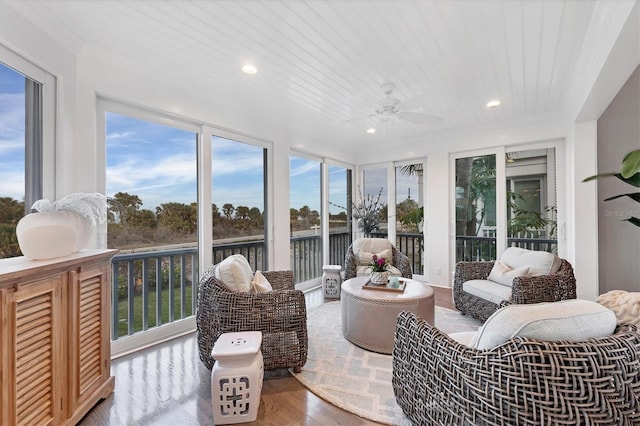 sunroom / solarium featuring ceiling fan