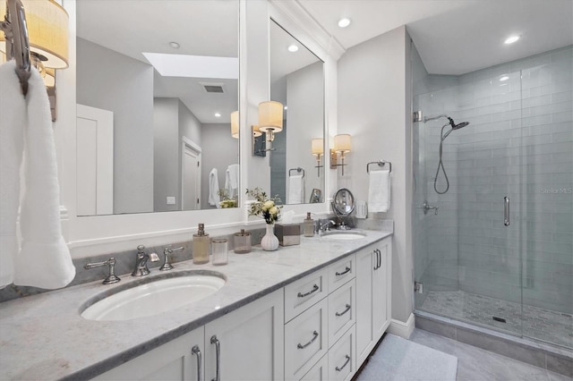 bathroom with vanity and a shower with door