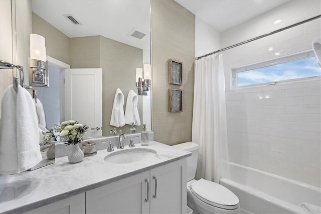 full bathroom featuring vanity, toilet, and shower / bath combination with curtain