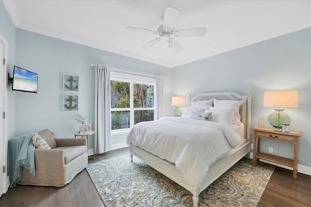 bedroom with ceiling fan, dark hardwood / wood-style floors, and ornamental molding