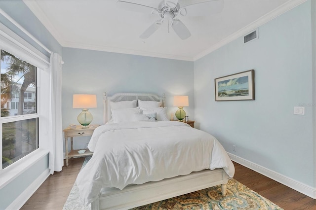 bedroom featuring dark hardwood / wood-style floors, ceiling fan, and ornamental molding