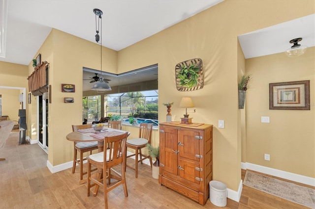 dining space with ceiling fan and light wood-type flooring