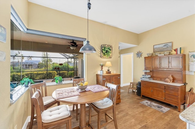 dining space featuring ceiling fan and light wood-type flooring