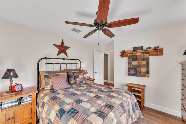 bedroom with light hardwood / wood-style flooring and ceiling fan