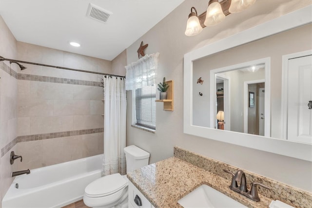 full bathroom with vanity, toilet, and shower / tub combo