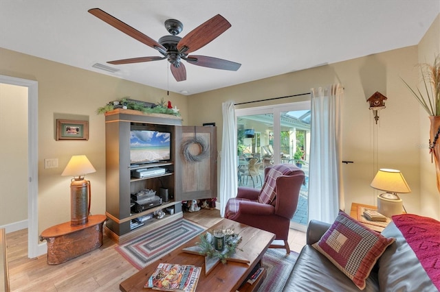 living room featuring ceiling fan and wood-type flooring