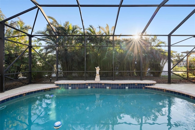 view of pool with glass enclosure