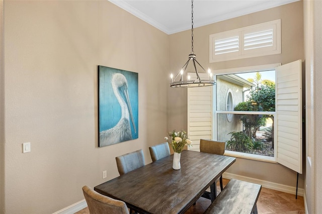 dining space featuring baseboards, a chandelier, and crown molding