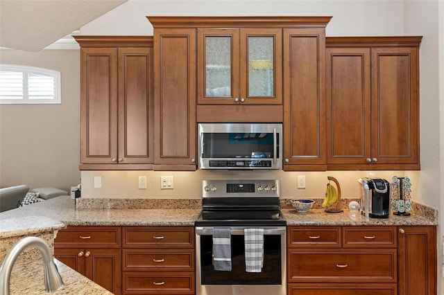 kitchen featuring light stone countertops and appliances with stainless steel finishes