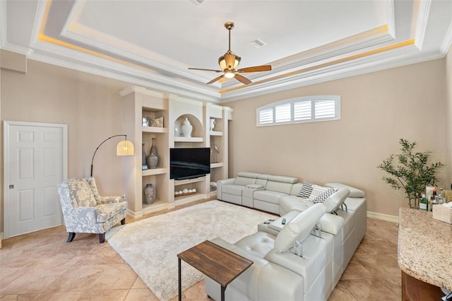 living room with light tile patterned flooring, ceiling fan, ornamental molding, and a raised ceiling