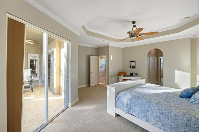 carpeted bedroom with ceiling fan, ornamental molding, a raised ceiling, and multiple windows