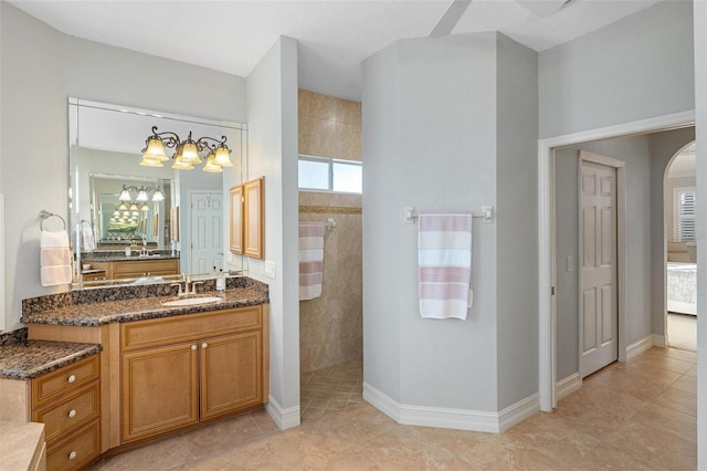 bathroom with vanity, tile patterned flooring, and a shower