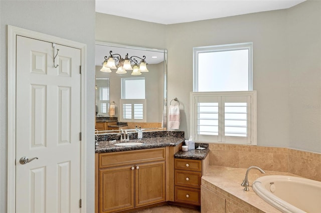 bathroom featuring vanity and tiled tub