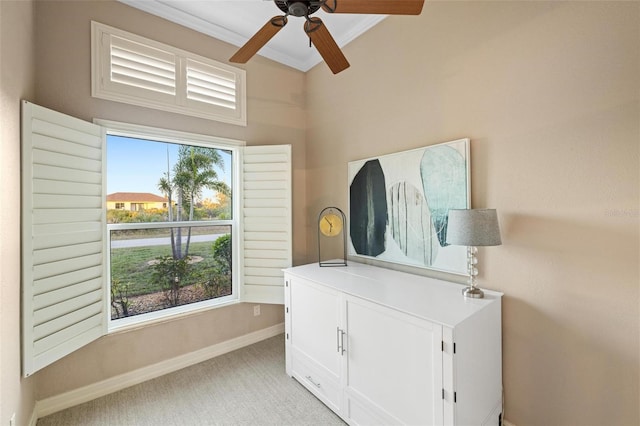 interior space with multiple windows, crown molding, and ceiling fan