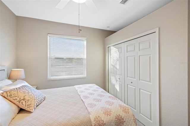 bedroom with a closet, visible vents, and a ceiling fan