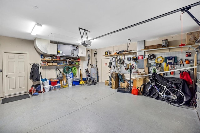 garage with a garage door opener, water heater, and a workshop area