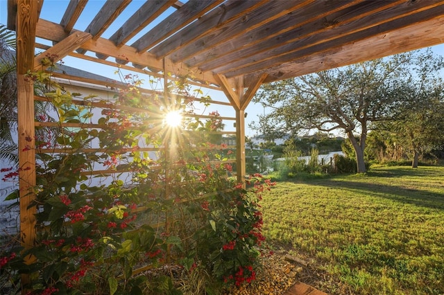 view of yard with a water view and a pergola