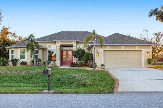 view of front of house featuring concrete driveway, a garage, a front yard, and stucco siding