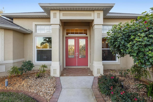 entrance to property with french doors and stucco siding