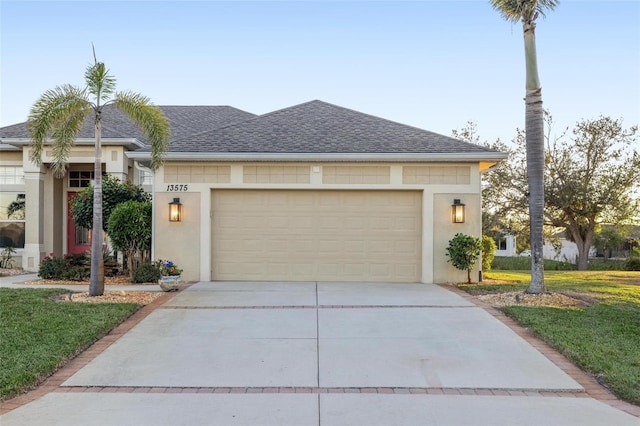 view of front of home featuring a shingled roof, a garage, driveway, and stucco siding