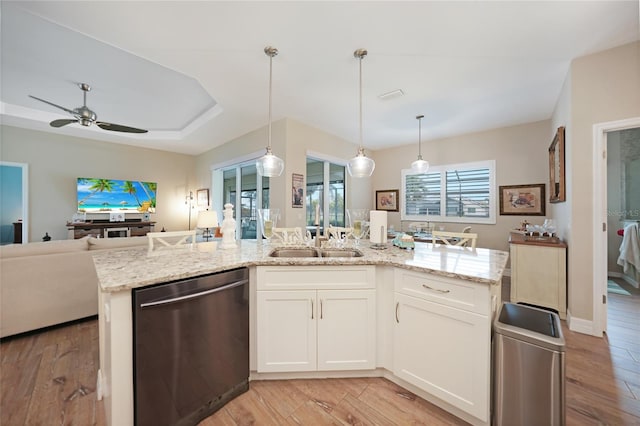 kitchen with white cabinetry, dishwasher, an island with sink, hanging light fixtures, and light hardwood / wood-style floors