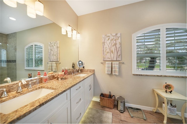 bathroom with hardwood / wood-style flooring, vanity, and an enclosed shower