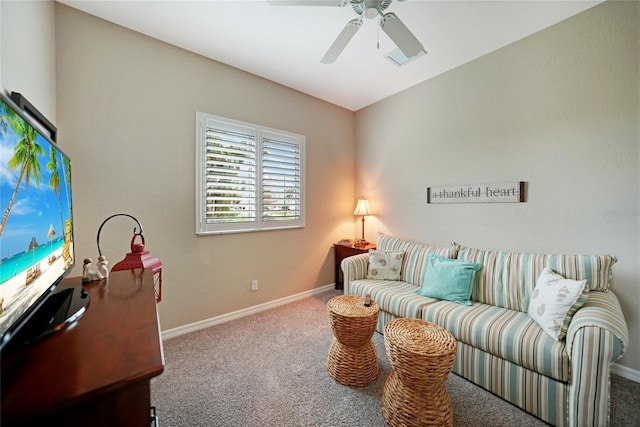 carpeted living room with ceiling fan