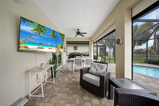 sunroom / solarium with a healthy amount of sunlight and ceiling fan